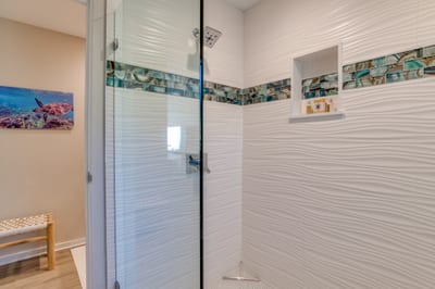 Imagine rinsing off after a beach day in this breezy retreat, wrapped in cool tile and the calming colors of the sea KGV-17T5
