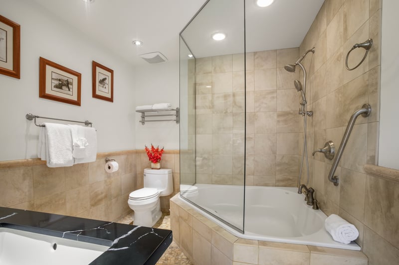 This bathroom offers a warm wooden embrace and a soaking tub that says “ahhh” louder than your vacation playlist KGV-17V3