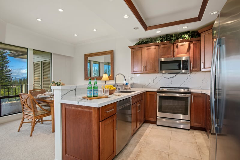This kitchen pairs rich wood tones with crisp marble textures—perfect for morning brews and sunset sips alike KGV-17V3