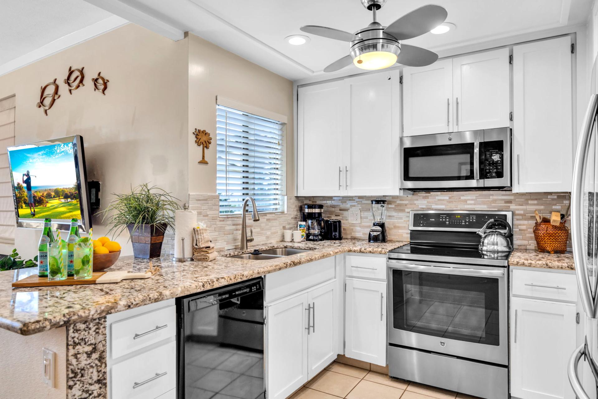 Stainless appliances and a tiled backsplash complete this chef-ready kitchen setup.