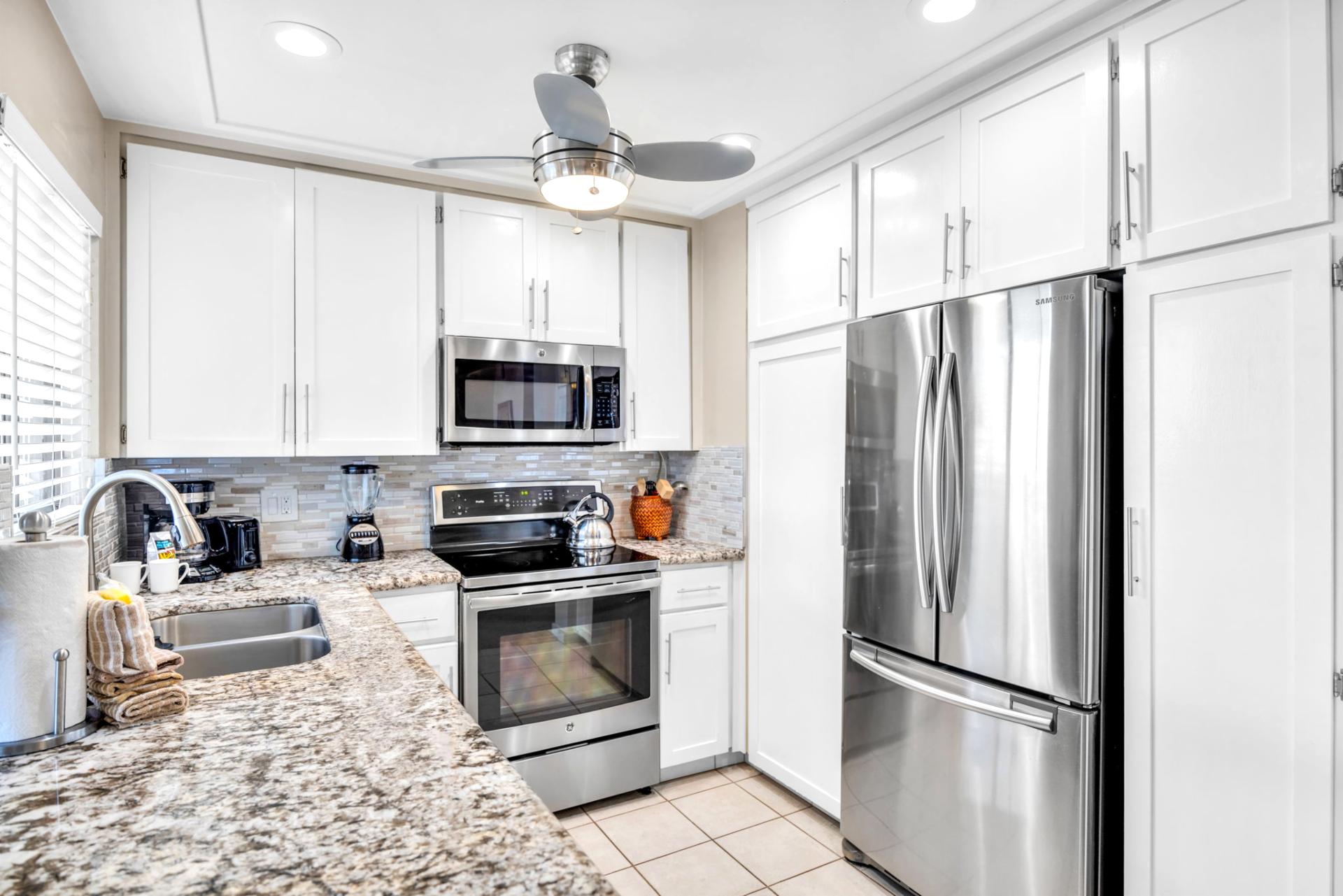 All the essentials are here in this open kitchen, featuring granite counters and full-size appliances.