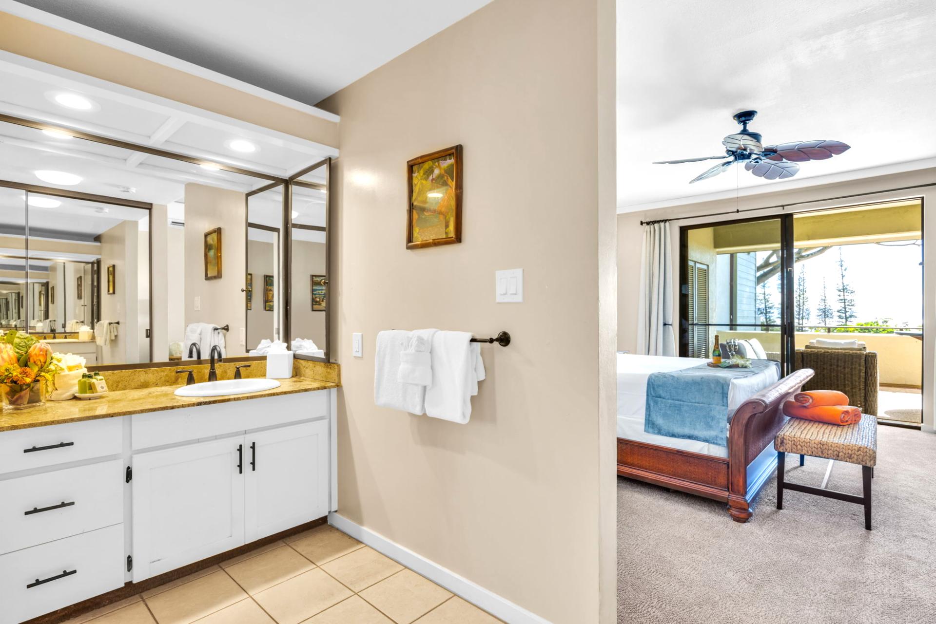 Spacious master bath with large vanity and soaking tub for relaxed vacation routines.
