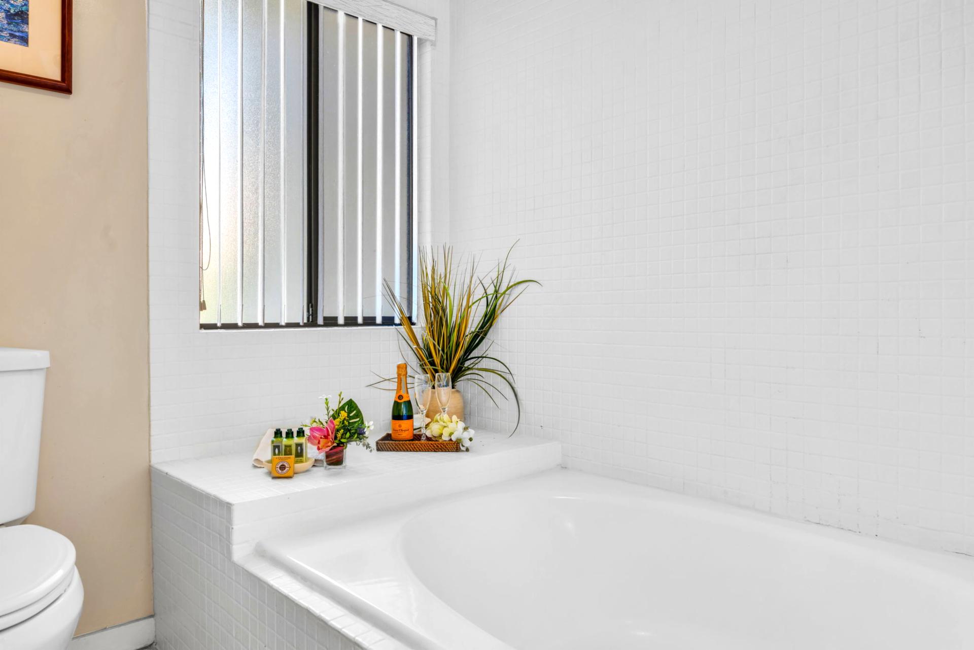 Soaking tub and bright natural light make this en-suite bath feel open and spa-inspired.