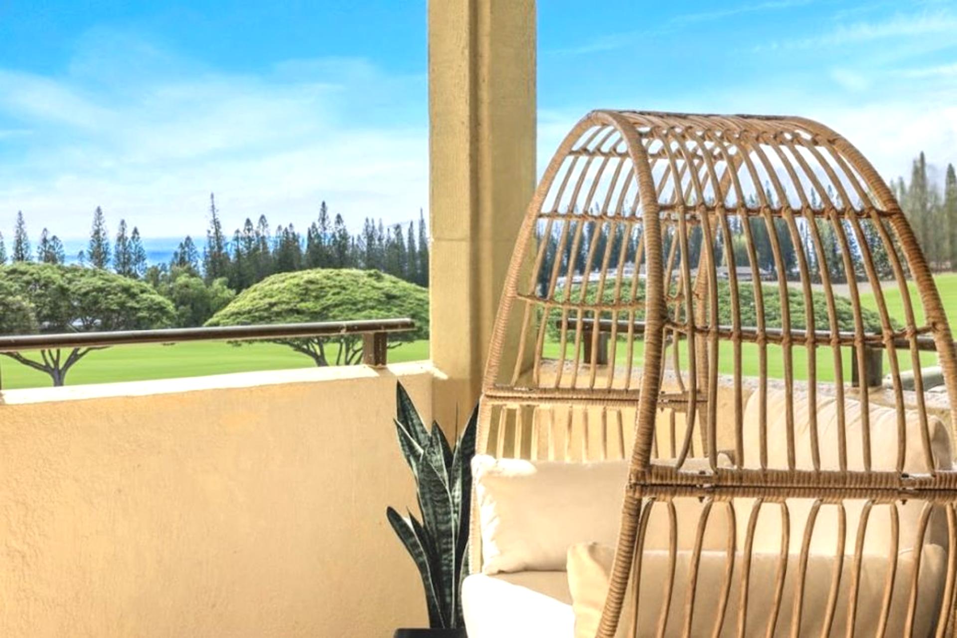 Chic rattan seating and expansive golf course views make this lanai a standout feature.