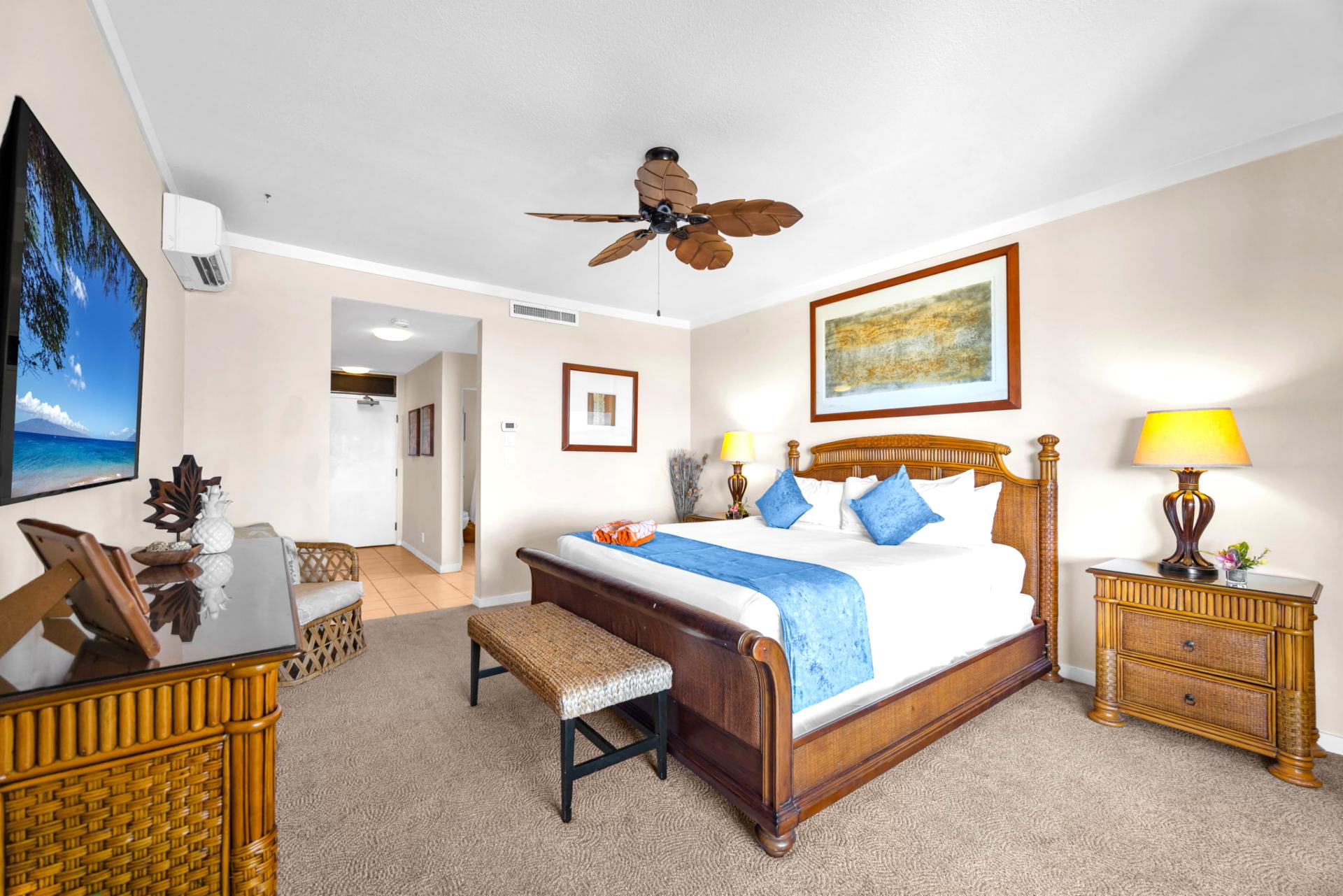 Spacious primary bedroom with King bed and tropical artwork offers a quiet place to recharge.