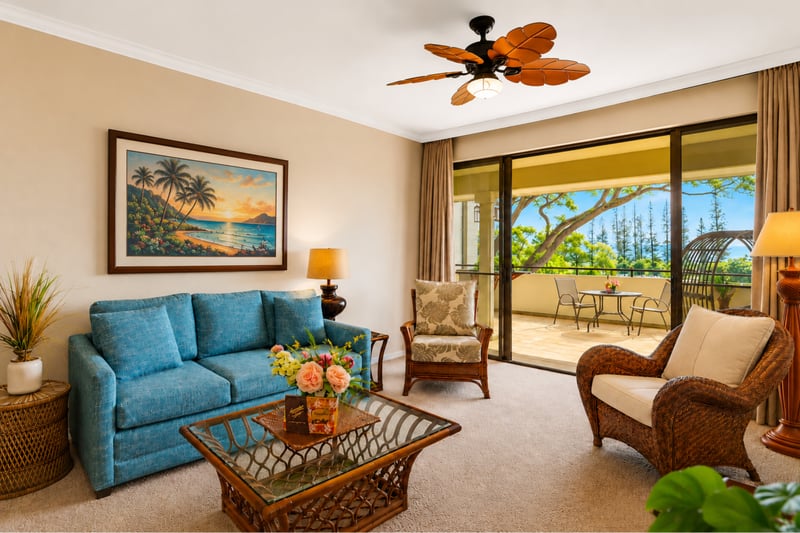 The open-concept living area features a ceiling fan, comfortable seating, and views that carry the outdoors in. KGV-18T4