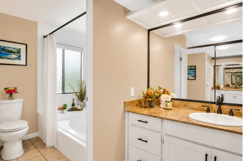 Your primary en-suite bathroom features a soaking tub and shower combination, with clean tilework and plenty of counter space. KGV-18T4