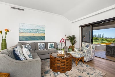 Island flair and comfort collide, featuring vibrant art, soft seating, and easy access to the outdoors KGV-19P2