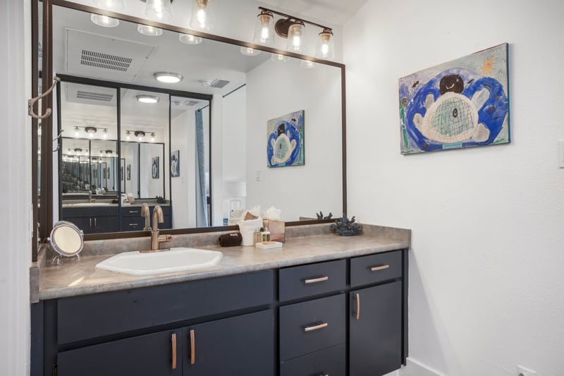 Polished finishes and breezy charm, this guest bath is a gentle exhale after a day of travel   