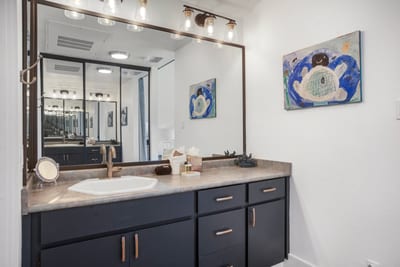 Polished finishes and breezy charm, this guest bath is a gentle exhale after a day of travel