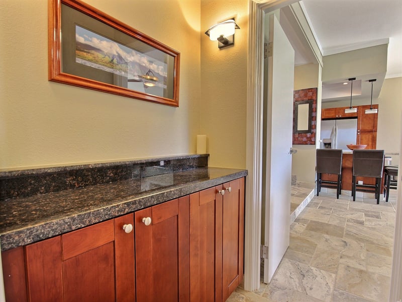 Sophisticated granite wet bar with custom cabinetry—perfect for elegant entertaining steps from the gourmet kitchen and dining area     KGV-19P3