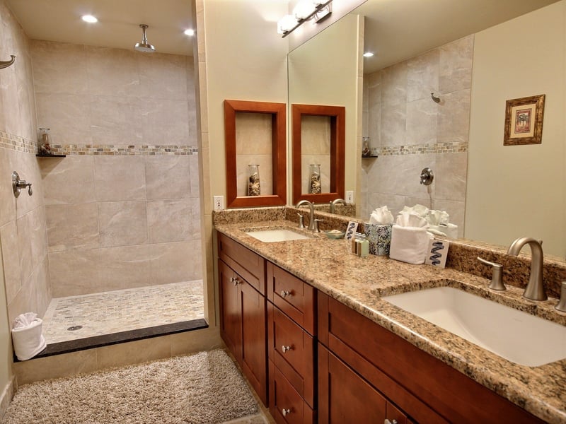 Step into the soft light, feel the warmth of the tile, and let the rain shower rinse away the day’s adventures in pure comfort