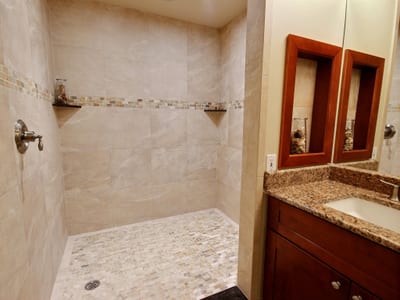 From mirror to marble and rain to refresh, this guest bath offers a quiet pause between beach walks and sunset views