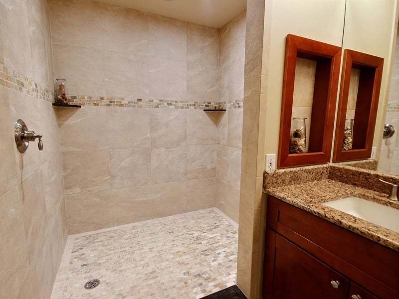 From mirror to marble and rain to refresh, this guest bath offers a quiet pause between beach walks and sunset views