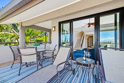 Lounge on a shaded lanai overlooking vibrant greenery and resort views. KGV-20T8