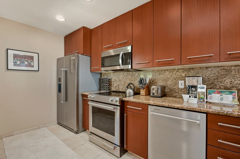 A modern kitchen with stainless steel appliances and granite countertops, perfect for prepping your vacation meals. KGV-20T8