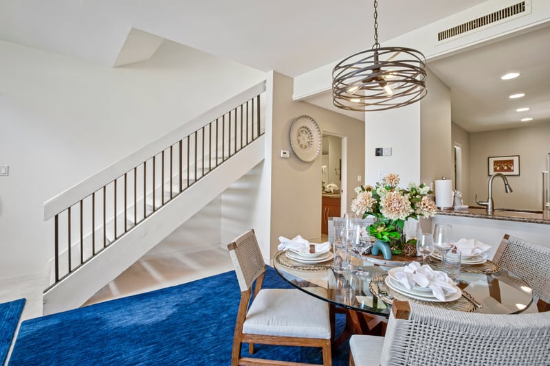 Bright, open dining with staircase views and elegant ambiance. KGV-20T8