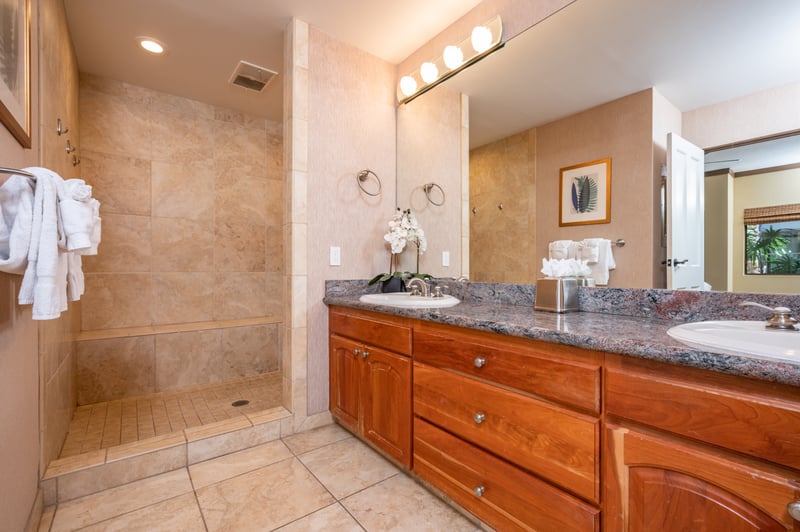 The perfect mix of function and flair, this elegant bathroom offers a private escape with double vanities and a spacious glass shower