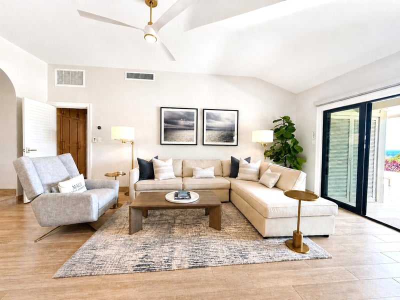 The spacious living room features a comfortable sectional sofa and arm chair for cozy nights in