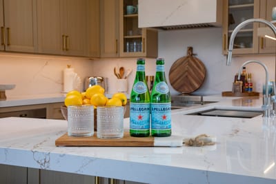 Your welcome starts at the kitchen counter—fresh lemons, sparkling water, and everything set for a refreshing arriva