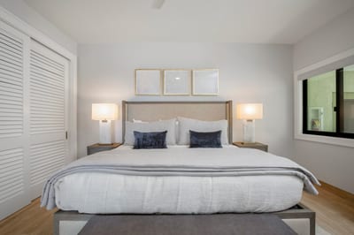 Wrapped in soft grays and golden light, this room feels like a warm hug from the island itself—elegance made effortless