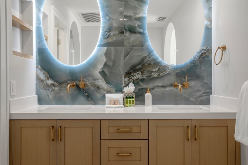 From the radiant mirrors to the glistening sea-tile walls, every detail in this guest bath is a treat for the senses