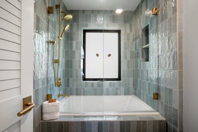 A tub designed to slow time—gracefully surrounded by natural stone and subtle artistry, it’s your personal retreat