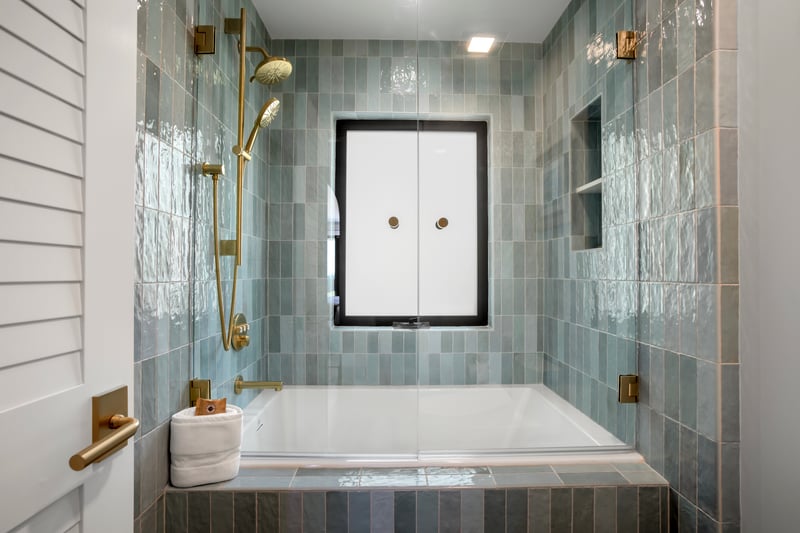 A tub designed to slow time—gracefully surrounded by natural stone and subtle artistry, it’s your personal retreat