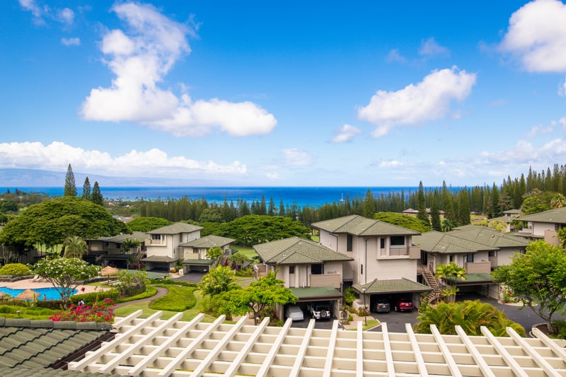 Gaze across rolling treetops and emerald rooftops to the indigo sea—where luxury living meets natural wonder every day