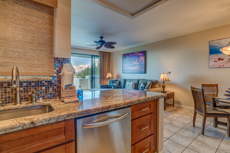 Cook with care in a kitchen where rich wood cabinetry and mosaic tile accents blend beauty, warmth, and culinary inspiration