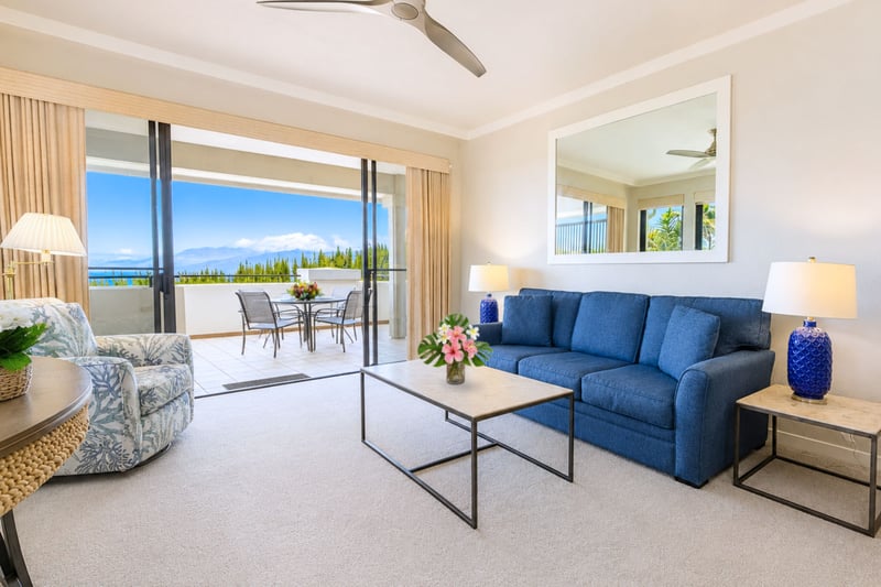 Sliding glass doors connect the living room to the lanai, blending indoor comfort with Maui's year-round breeze and ocean views.