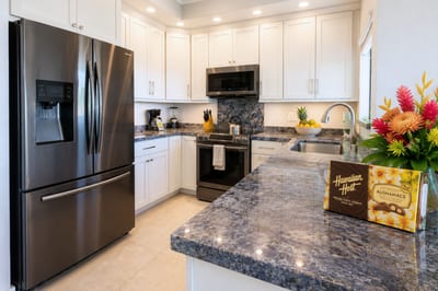 Fully equipped kitchen with stainless appliances and granite counters, everything you need to cook in or grab a quick bite before the beach.