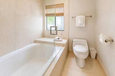 Soak away a day on the golf course or beach in the primary suite's deep soaking tub, tucked beneath a garden window.