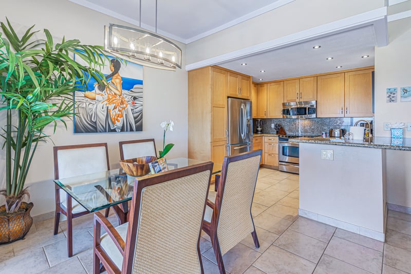 Savor tropical vibes in every bite with a stylish dining room that seamlessly blends indoor comfort with outdoor scenery