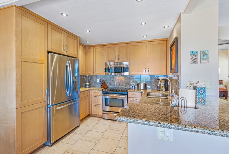 With stainless steel elegance and granite warmth, this kitchen is ready for both casual bites and celebration feasts    
