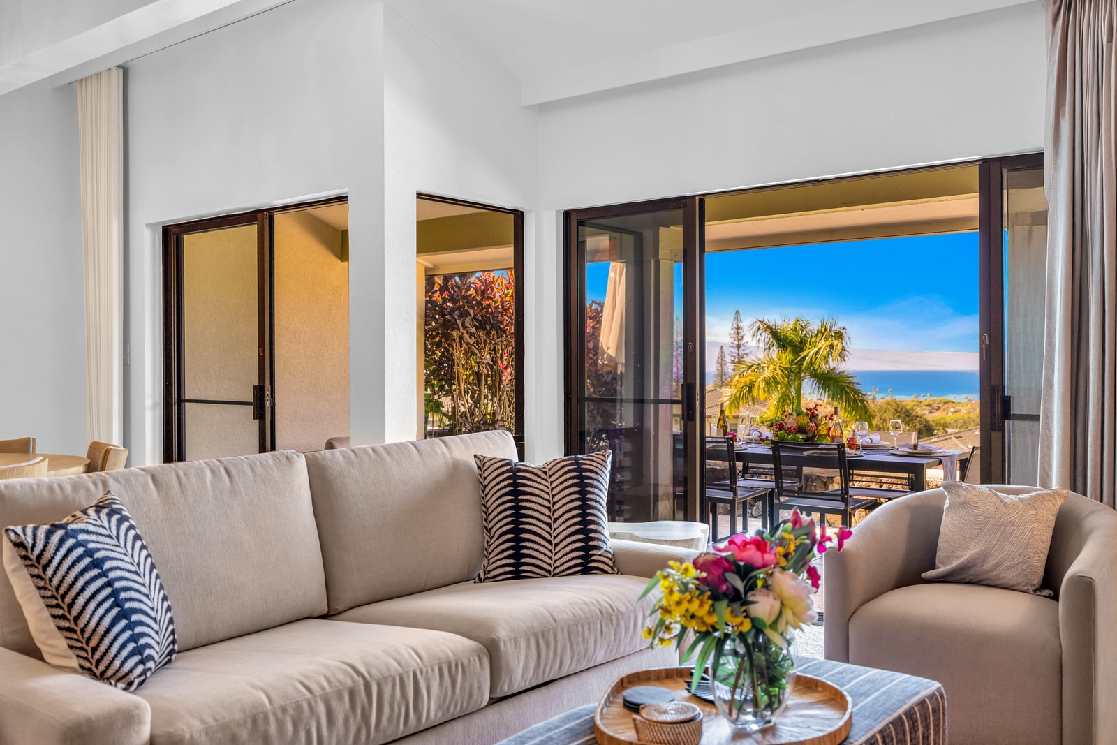 Sink into plush seating in the living area with sliding doors opening to the lanai and ocean views. KGV-24P7