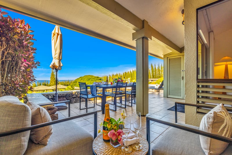 Relax on cushioned lanai seating while overlooking the resort and catching ocean views through the palms.