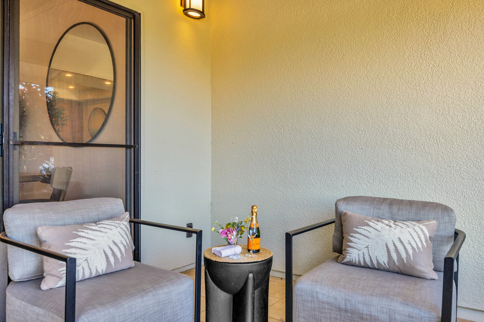 A cozy lanai seating corner offers a quiet place to read or sip a drink in the open air. KGV-24P7