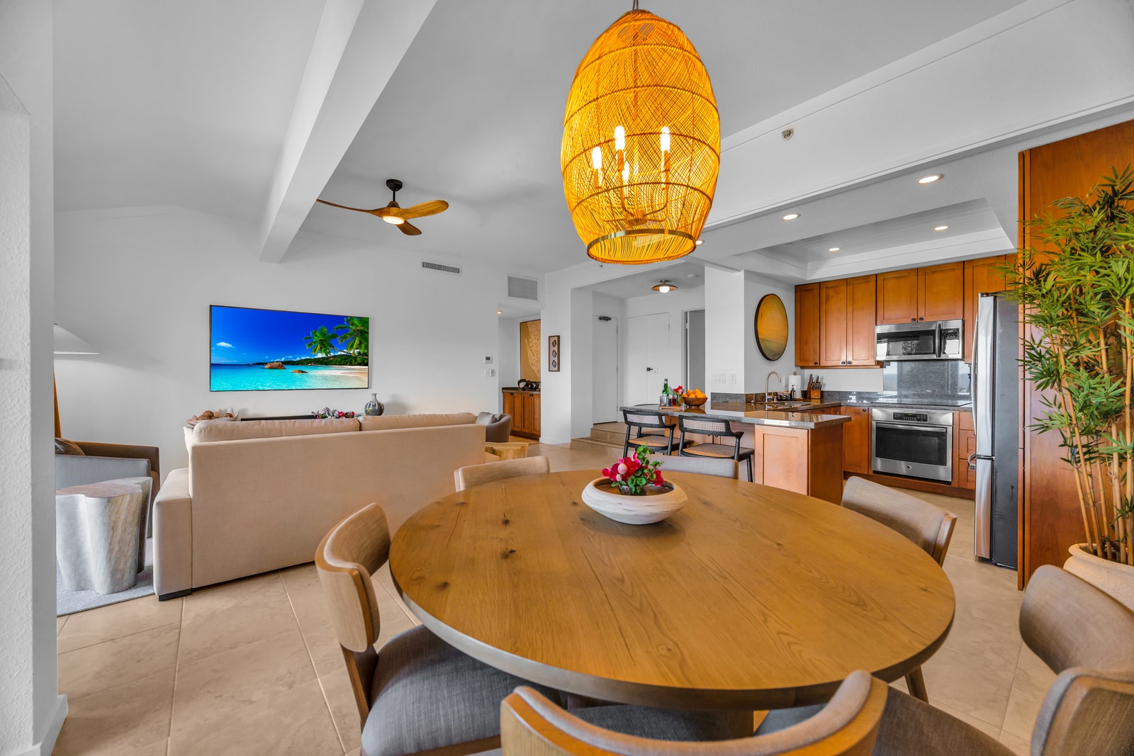 A warm dining space anchors the open layout between the kitchen and living area. KGV-24P7