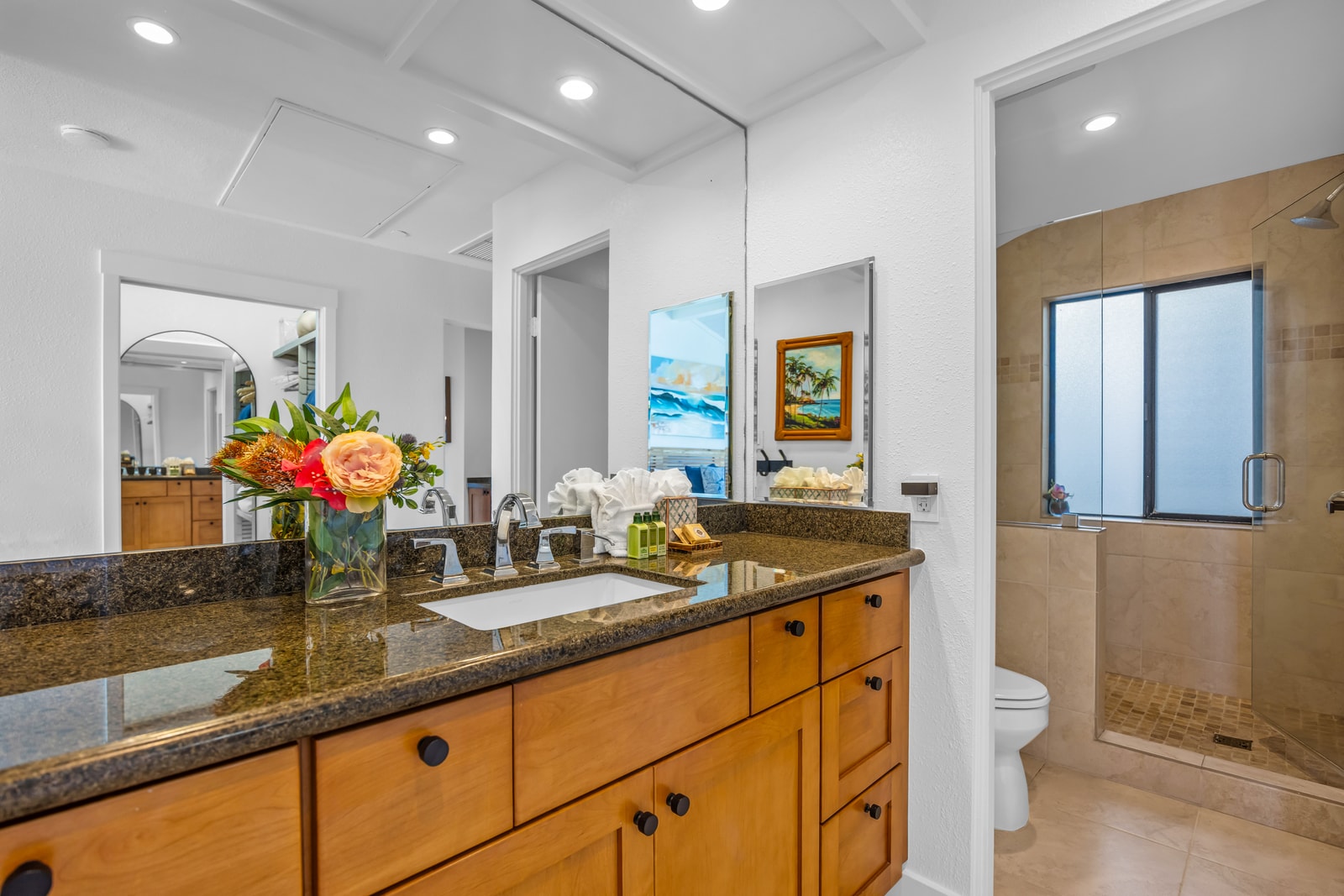 The guest bath features a granite vanity and convenient access from the guest bedroom.