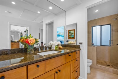 The guest bath features a granite vanity and convenient access from the guest bedroom.