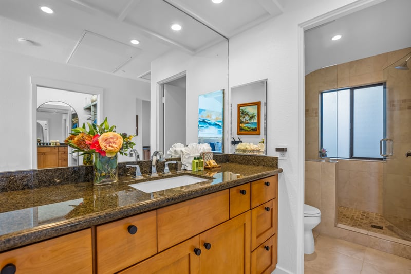 The guest bath features a granite vanity and convenient access from the guest bedroom.