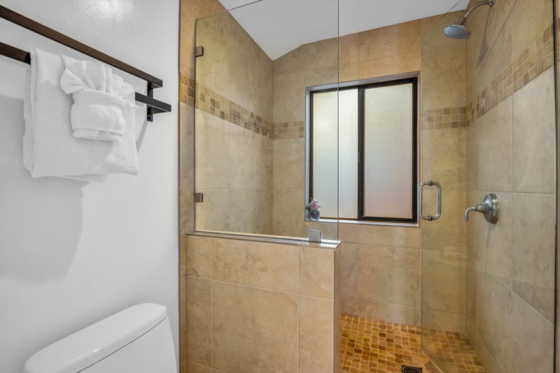 A tiled shower and clean finishes make the guest bathroom easy and comfortable to use.