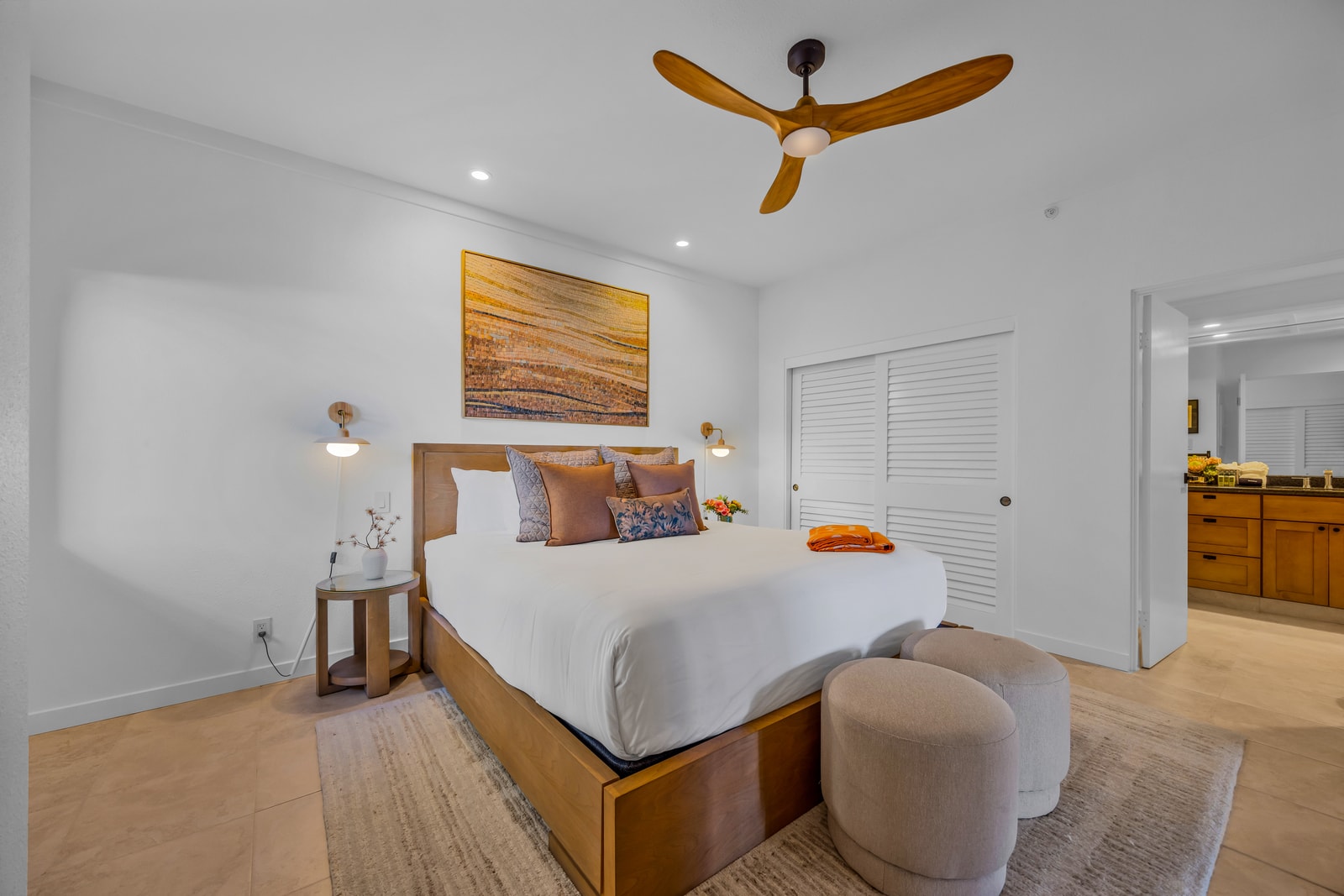 Comfortable bedding and soft lighting create a restful guest bedroom retreat. KGV-24P7