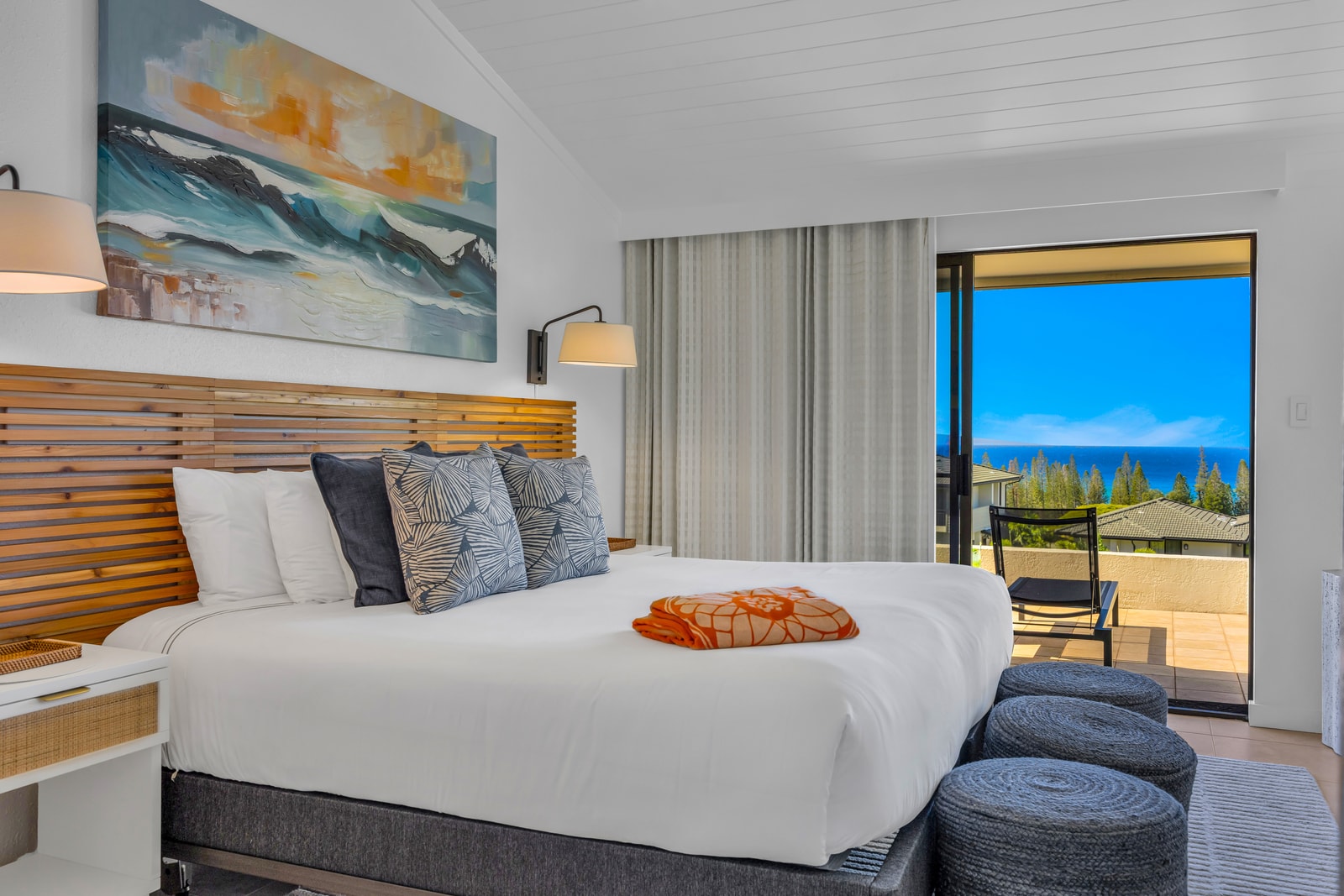 The primary bedroom features a King bed, soft seating, and peaceful resort and ocean views. KGV-24P7