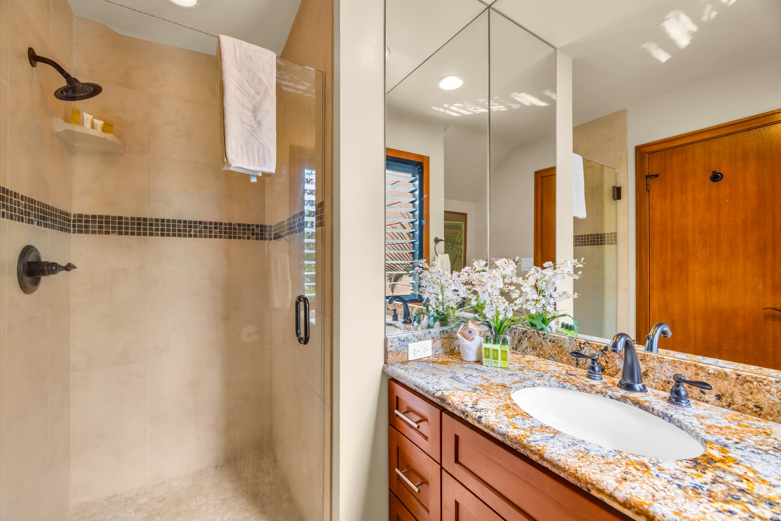 The guest bath features a walk in shower for convenience