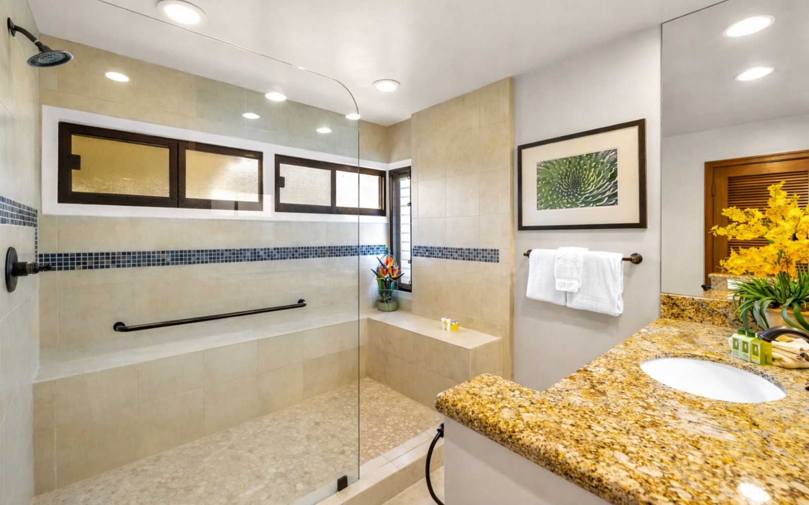The master bath features a modern glass shower and plenty of vanity space