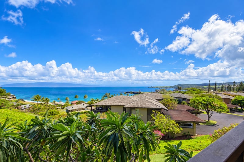 Panoramic ocean and coastline view with sweeping vistas of Napili Bay's turquoise waters framed by lush West Maui hillsides.