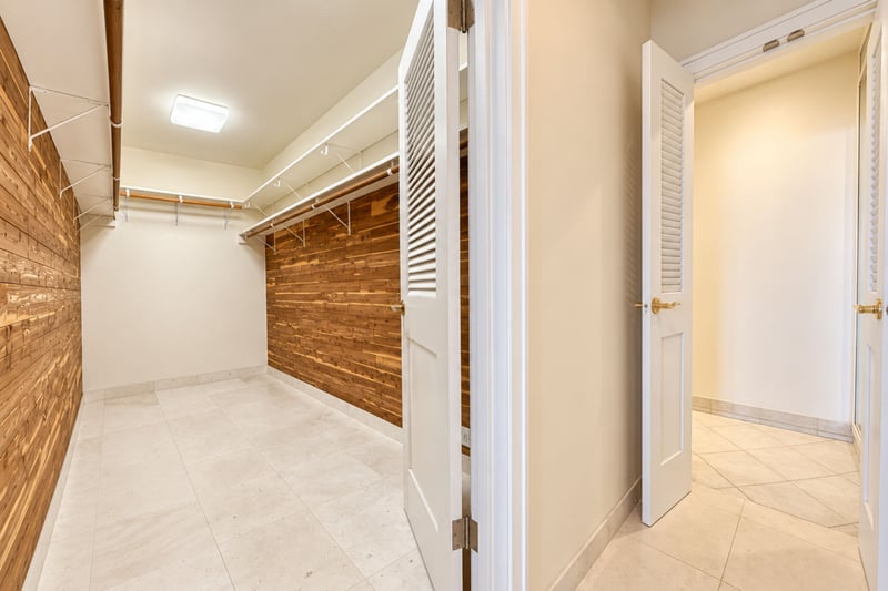 Spacious walk in closet with cedar lined shelving and hanging storage, ideal for extended stays.