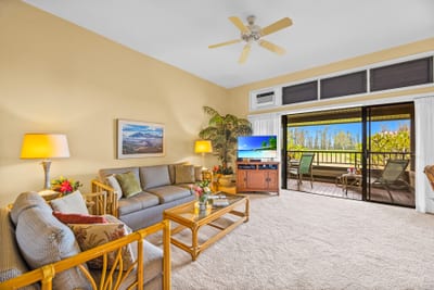 Open-concept living with plush seating and a Smart TV connects seamlessly to dining and kitchen areas.
